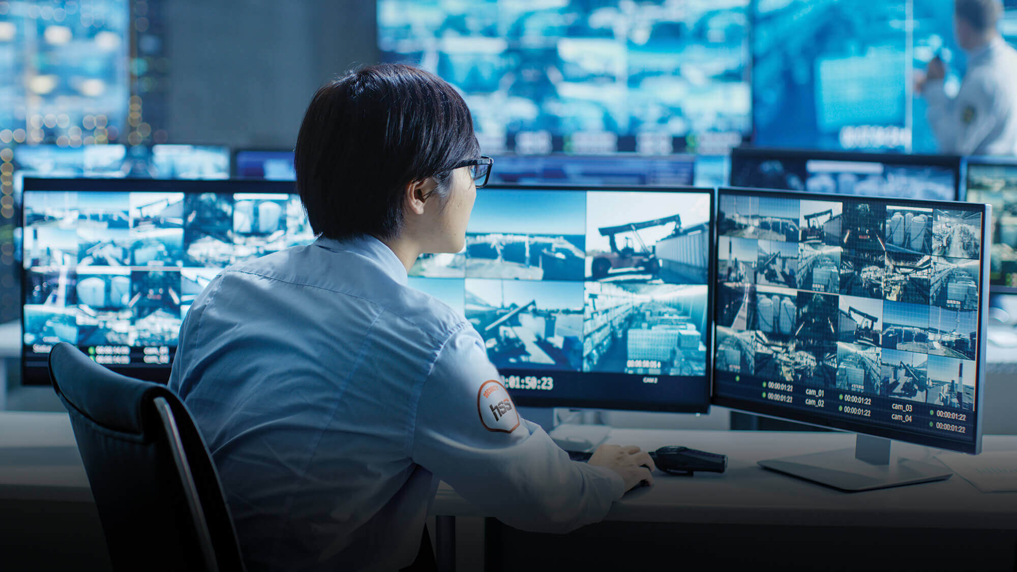 HSS employee looking at monitors.