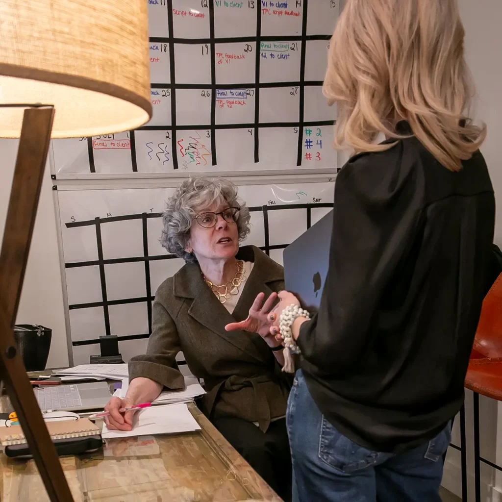 Amy Claire Wild discusses a project with Laura Love