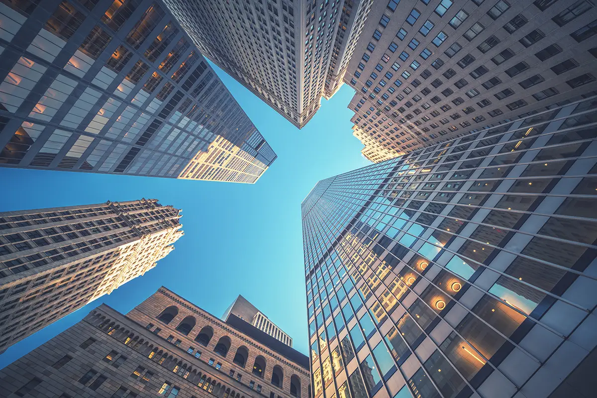 View looking up from the street of buildings in NYC, Wall Street