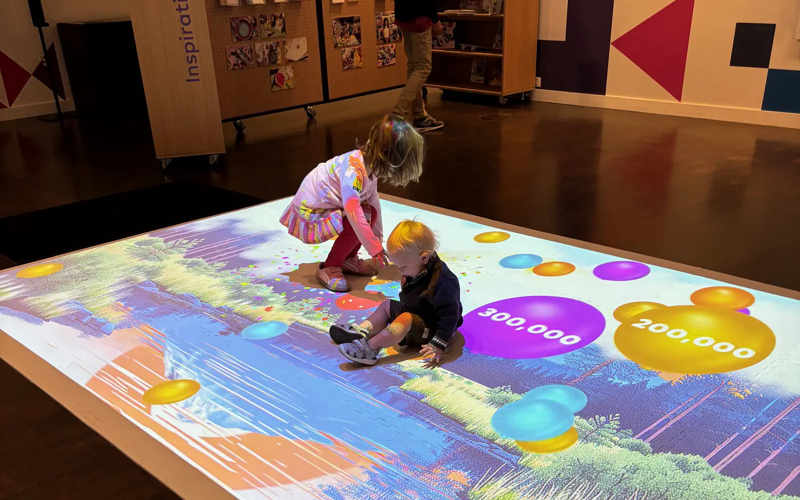 Two children play in the digital learning area of the Denver Art Museum during the Millionth Kid celebration
