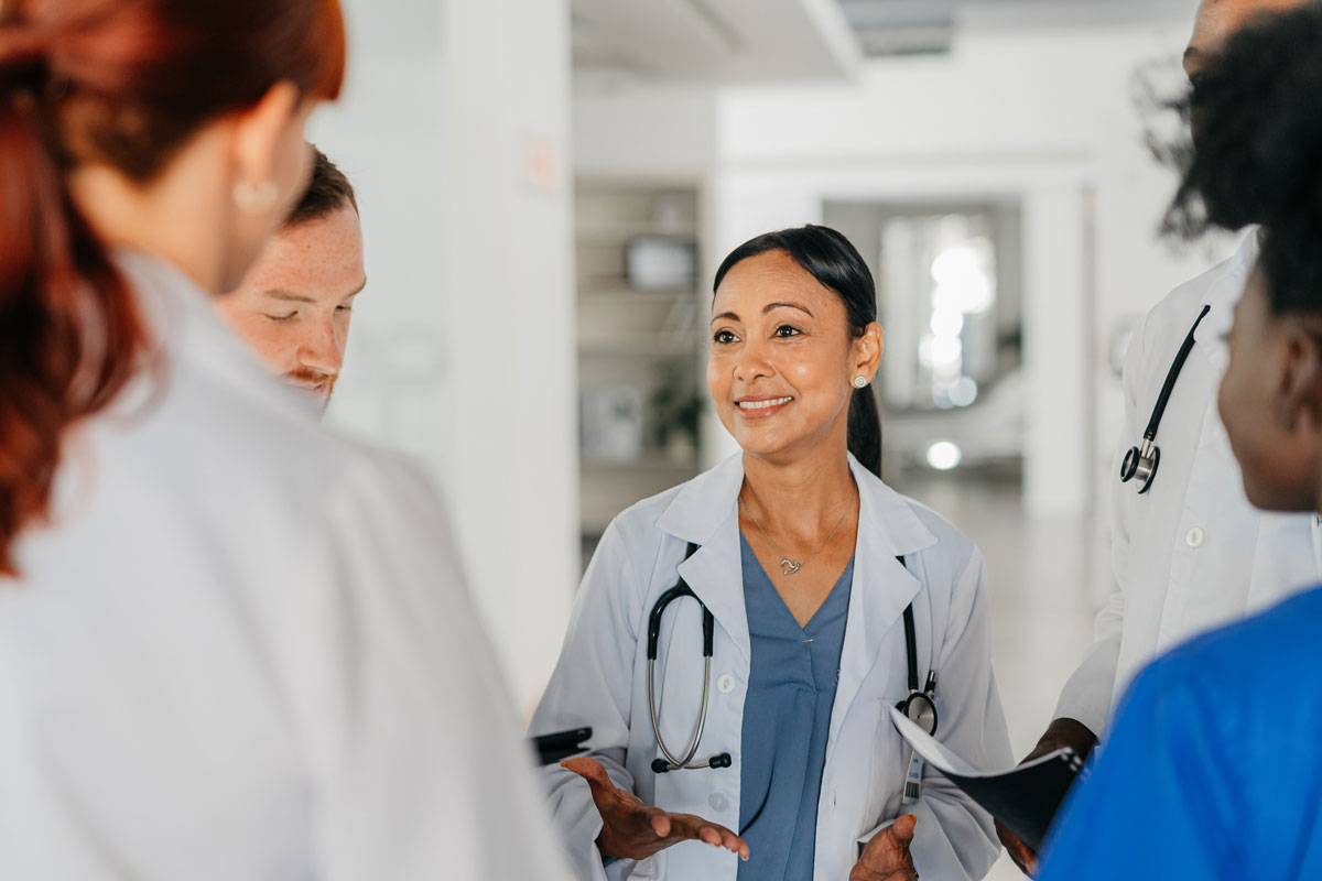A doctor speaks with coworkers