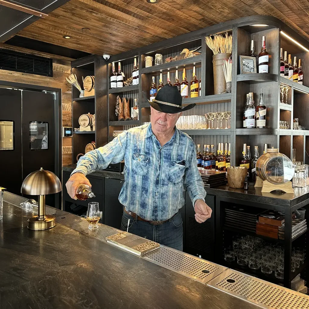 A man pouring a glass of whiskey at Stranahan's Aspen Tasting Lodge